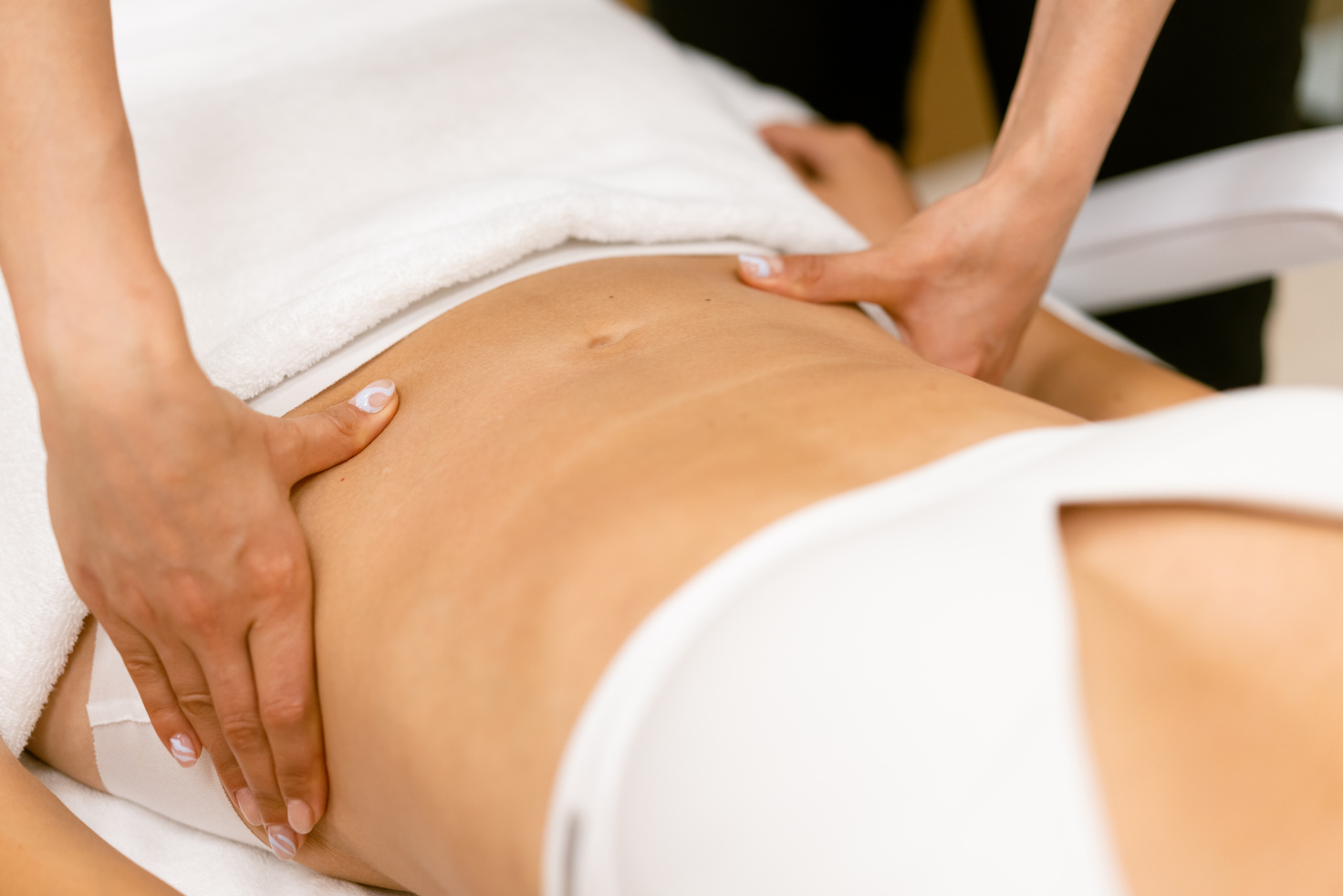 Middle-Aged Woman Having a Belly Massage in a Beauty Salon.